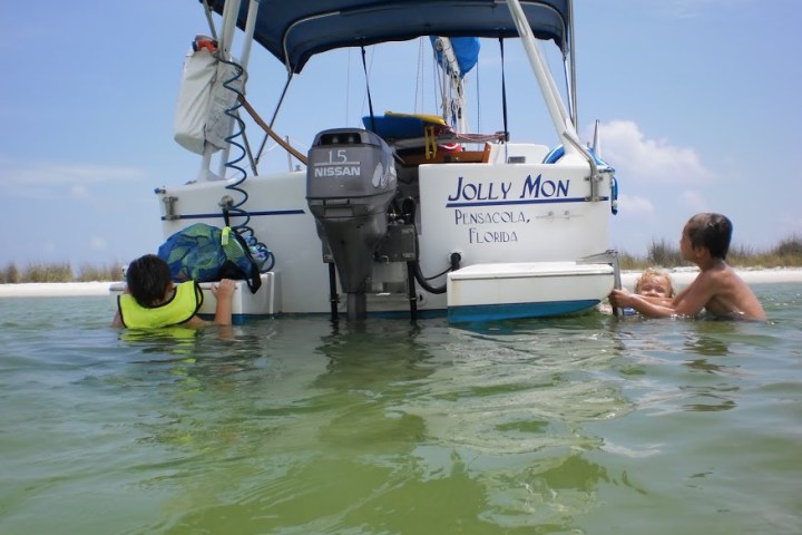 a person riding on the back of a boat in the water