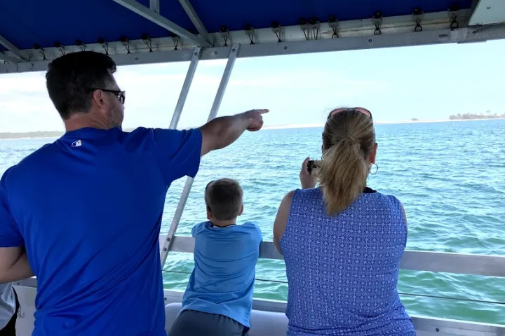 a man standing next to a body of water